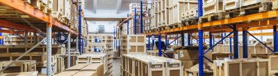 Logistic and distribution warehouse. Empty warehouse full of cargo. Cardboard boxes. Rows of shelves with paper boxes. Commercion concept
